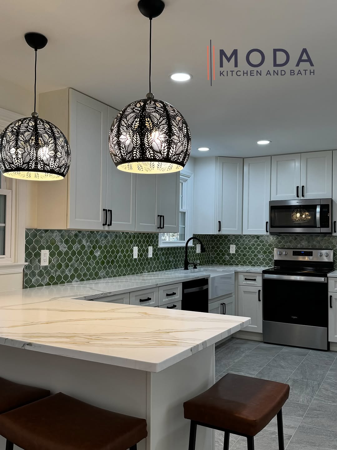 Kitchen remodel with white shaker cabinets, green arabesque tile backsplash, calacatta gold quartz island, moroccan pendant lights, and gray porcelain tile floor